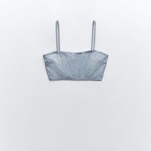 Straight neck crop top with thin straps. Rhinestone details.